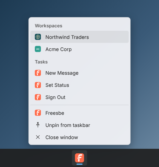 The Windows taskbar menu: Northwind Traders with its logo and Acme Corp with its initials under Workspaces, then New Message, Set Status and Sign Out